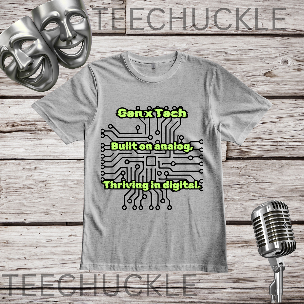 A gray graphic t-shirt displayed on a rustic wood background, featuring a black circuit board design with the green text 'Gen x Tech Built on analog, thriving in digital'