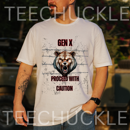 A man standing putdoors wearing a  white graphic t-shirt displayed on a rustic wood background, featuring a roaring bear illustration and the text 'GEN X PROCEED WITH CAUTION'. The shirt is accompanied by silver comedy masks and a vintage microphone prop.