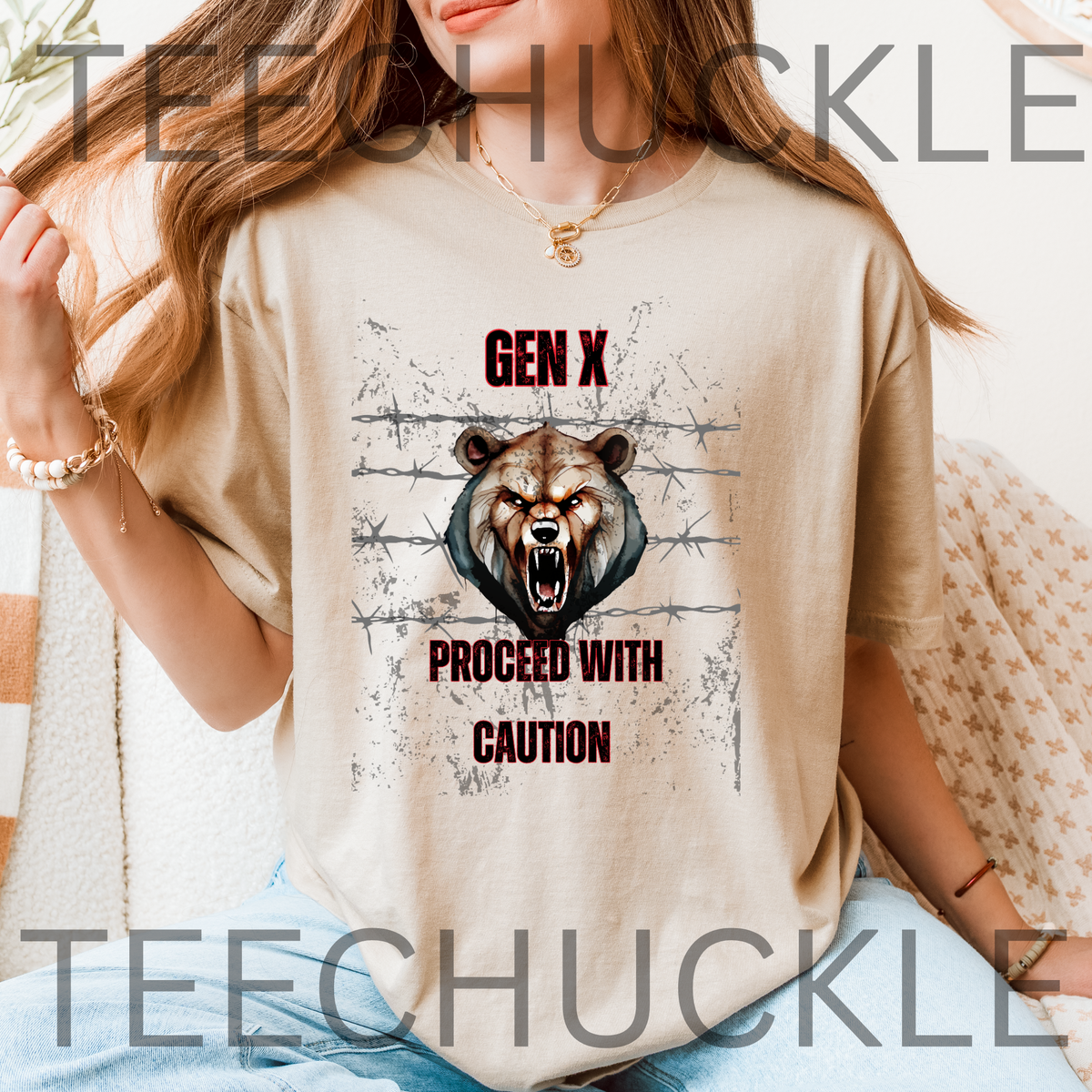 A woman wearing a sand graphic t-shirt featuring a roaring bear illustration and the text 'GEN X PROCEED WITH CAUTION'.