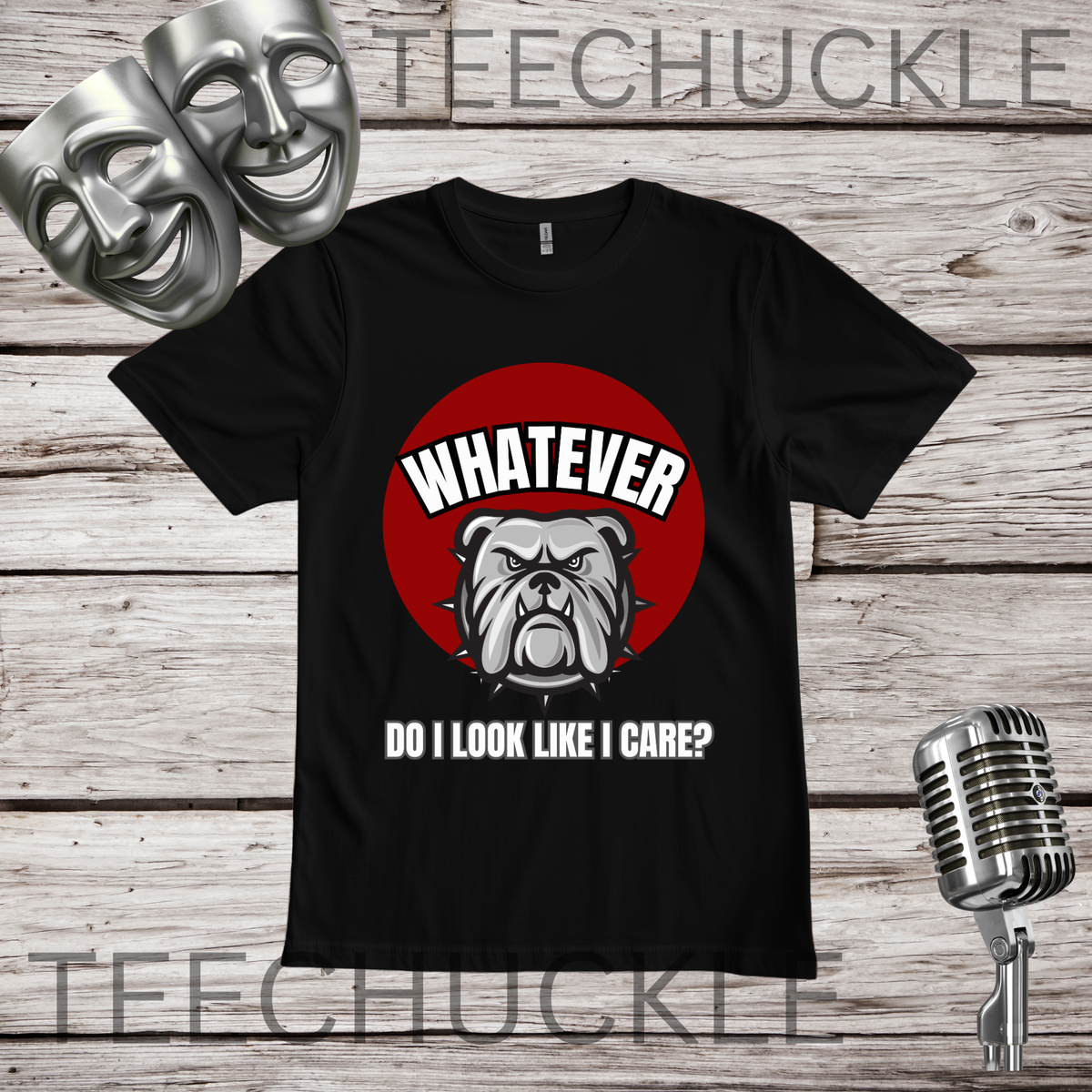 A black t-shirt on a wooden background with comedy masks and retro microphone in the corners. The shirt has a red circle with a bulldog on it and the text that reads " WHATEVER, DO I LOOK LIKE I CARE"