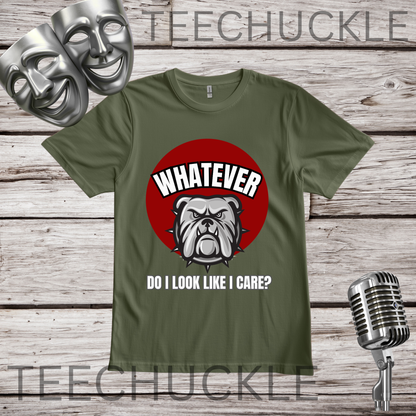 A green graphic t-shirt displayed on a rustic wooden background, featuring a red circle with a bulldog illustration and the text 'WHATEVER DO I LOOK LIKE I CARE?'. The image includes theatrical comedy and tragedy masks on the top left and a vintage microphone on the bottom right