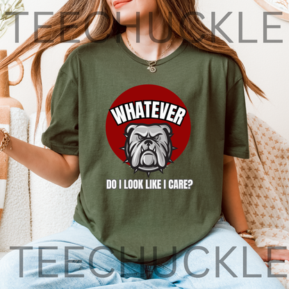 A woman wearing a green graphic t-shirt with a red circular bulldog design and the text 'WHATEVER DO I LOOK LIKE I CARE?' on the front, set against a cozy indoor background.