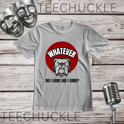 A gray graphic t-shirt featuring a red circle with a bulldog illustration and the text 'WHATEVER DO I LOOK LIKE I CARE?' on a rustic wood plank background, with a vintage microphone and comedy masks as props.