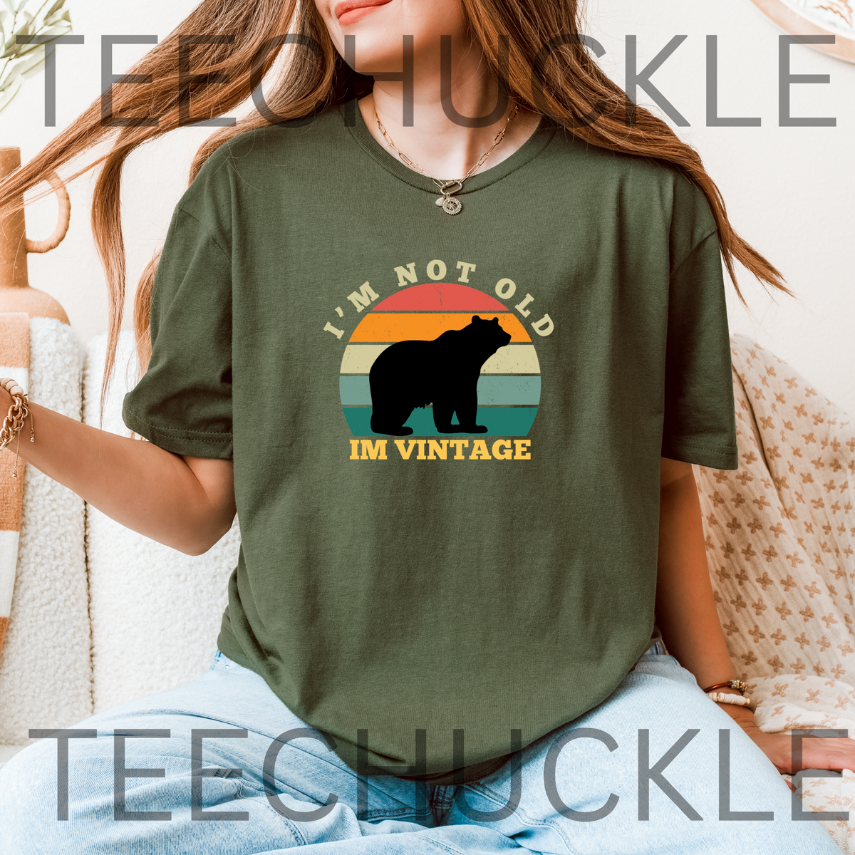 A woman wearing a green graphic t-shirt with a retro bear design and the text 'I'M NOT OLD IM VINTAGE'. 