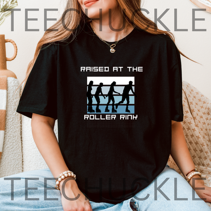 A woman wearing a black graphic t-shirt with a roller rink design and the text 'RAISED AT THE ROLLER RINK'. 