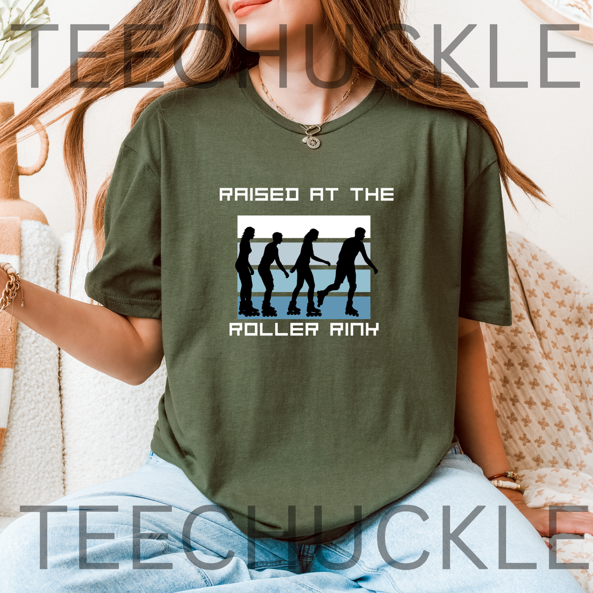 A woman wearing a green graphic t-shirt with the text 'RAISED AT THE ROLLER RINK' and a roller skate silhouette print, set against a cozy indoor background with a blanket 