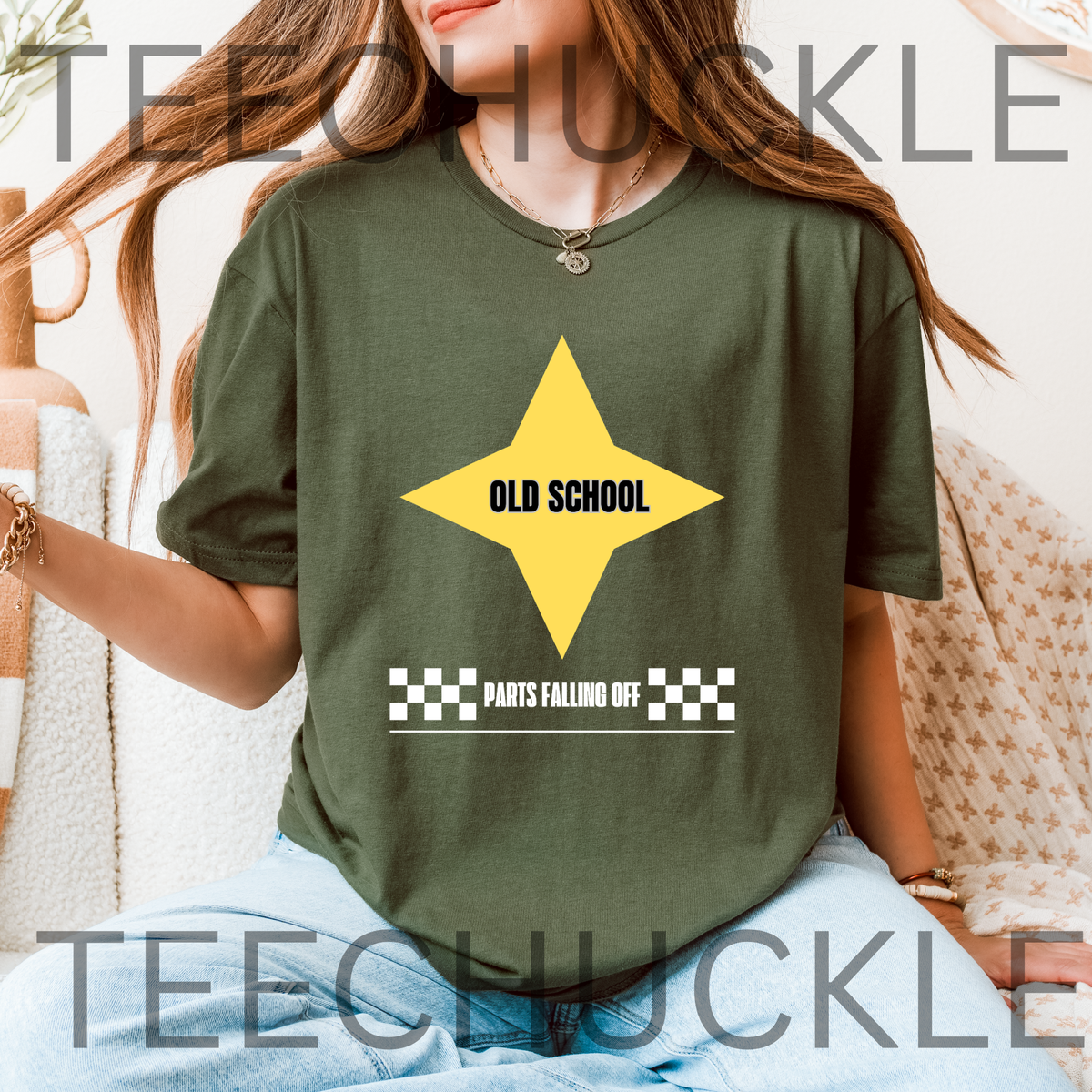 A woman wearing a green graphic t-shirt with a yellow star and the text 'OLD SCHOOL' and 'PARTS FALLING OFF'.