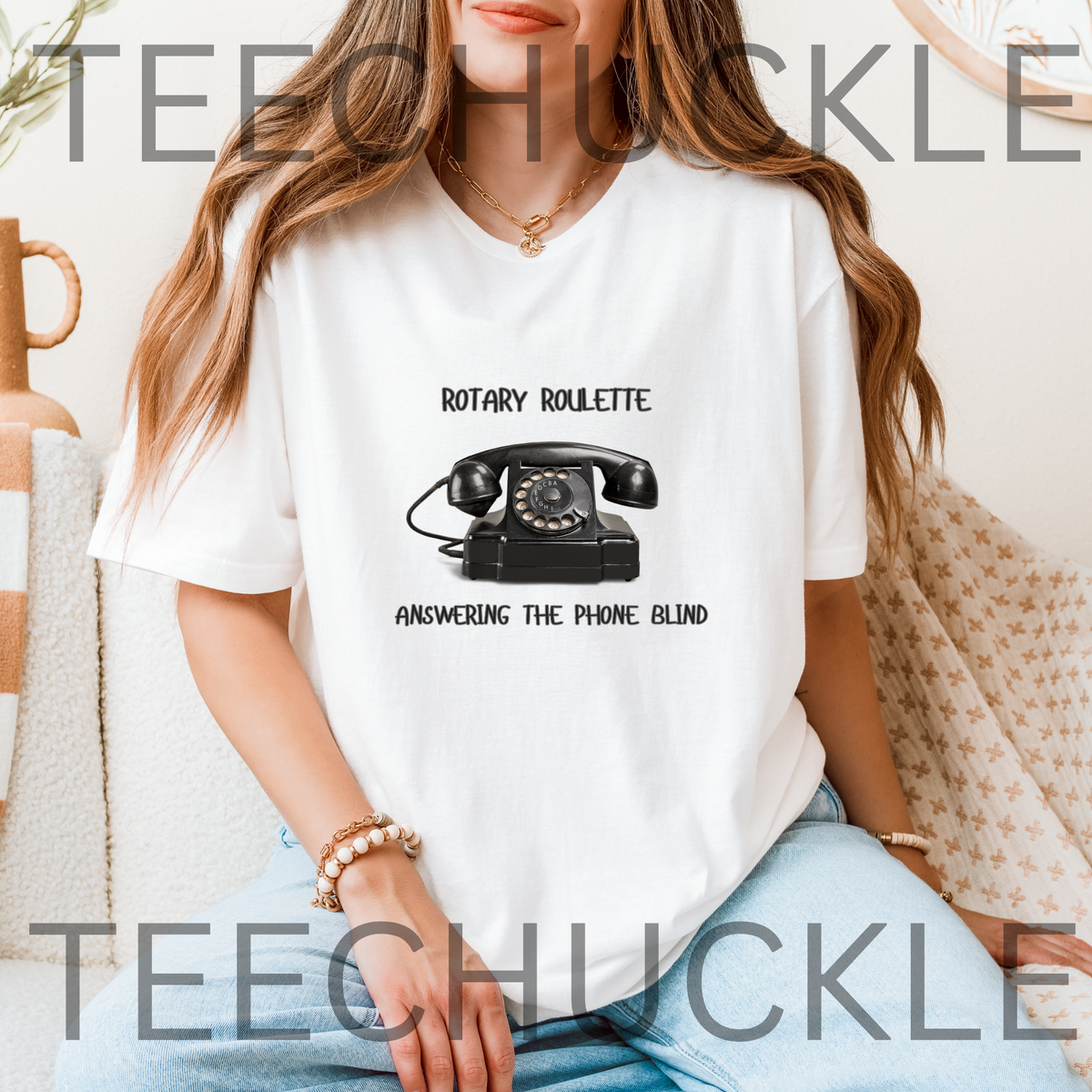 A woman wearing a white graphic t-shirt with a black rotary telephone print and the text 'ROTARY ROULETTE' and 'ANSWERING THE PHONE BLIND'.