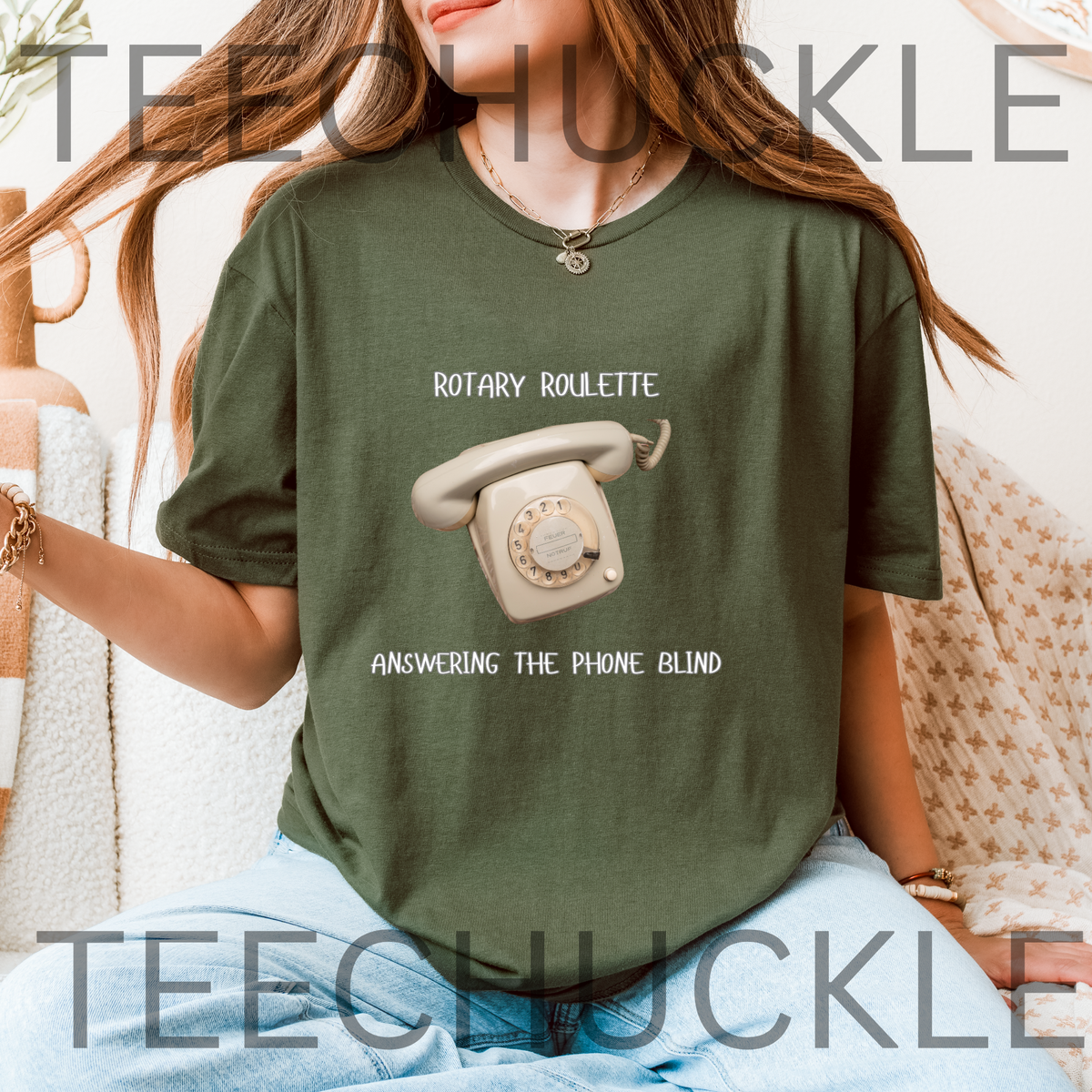 A woman wearing an oversized green t-shirt with a retro rotary phone graphic and the text 'ROTARY ROULETTE ANSWERING THE PHONE BLIND'. 