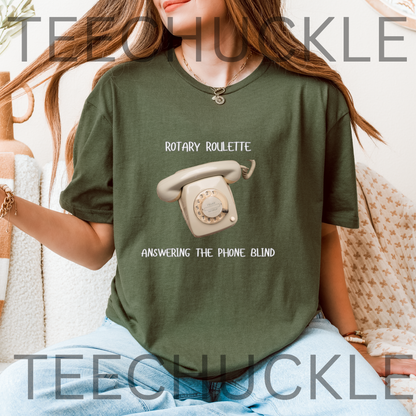 A woman wearing an oversized green t-shirt with a retro rotary phone graphic and the text 'ROTARY ROULETTE ANSWERING THE PHONE BLIND'. 