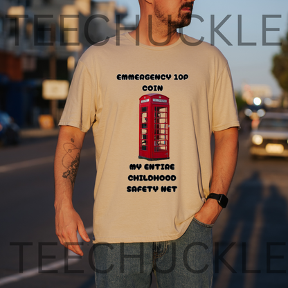 A man wearing a sand graphic t-shirt with a red telephone booth print and the text 'EMERGENCY 100 COIN MY ENTIRE CHILDHOOD SAFETY NET'.