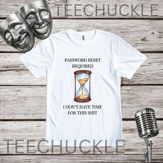 A white graphic t-shirt displayed on a rustic wood background, featuring a theater-themed design with two silver masks, a vintage microphone, and a central hourglass graphic with the text 'PASSWORD RESET REQUIRED I DON'T HAVE TIME FOR THIS SHIT'. 