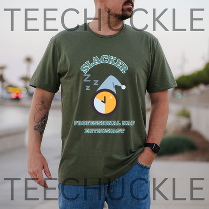 A man wearing an green graphic t-shirt with a 'Slacker Professional Nap Enthusiast' design, standing outdoors with a blurred background. The t-shirt features a sleeping clock graphic with a blue sleep mask and teal text.