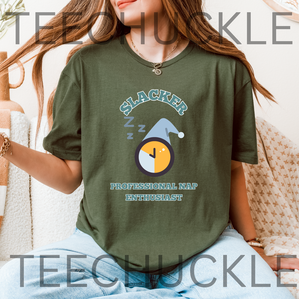 A woman wearing an oversized green graphic t-shirt with a 'Slacker professional nap enthusiast' sleep-themed design, paired with light blue jeans. 