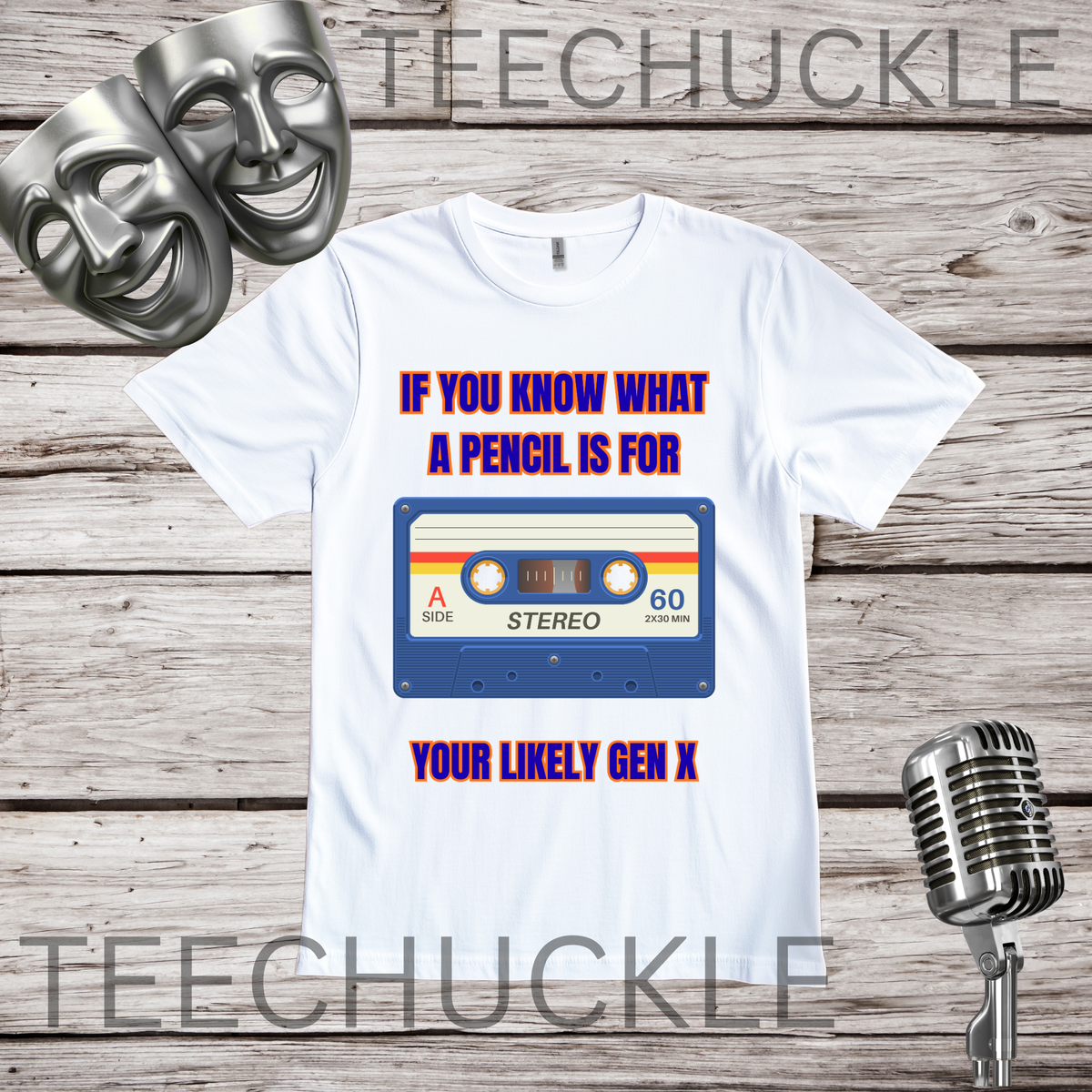 A white graphic t-shirt displayed on a rustic wood background, featuring a retro cassette tape design with the text 'IF YOU KNOW WHAT A PENCIL IS FOR YOUR LIKELY GEN X'. The t-shirt is decorated with two silver comedy masks on the top left and a vintage microphone on the bottom right.