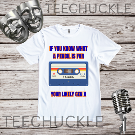 A white graphic t-shirt displayed on a rustic wood background, featuring a retro cassette tape design with the text 'IF YOU KNOW WHAT A PENCIL IS FOR YOUR LIKELY GEN X'. The t-shirt is decorated with two silver comedy masks on the top left and a vintage microphone on the bottom right.