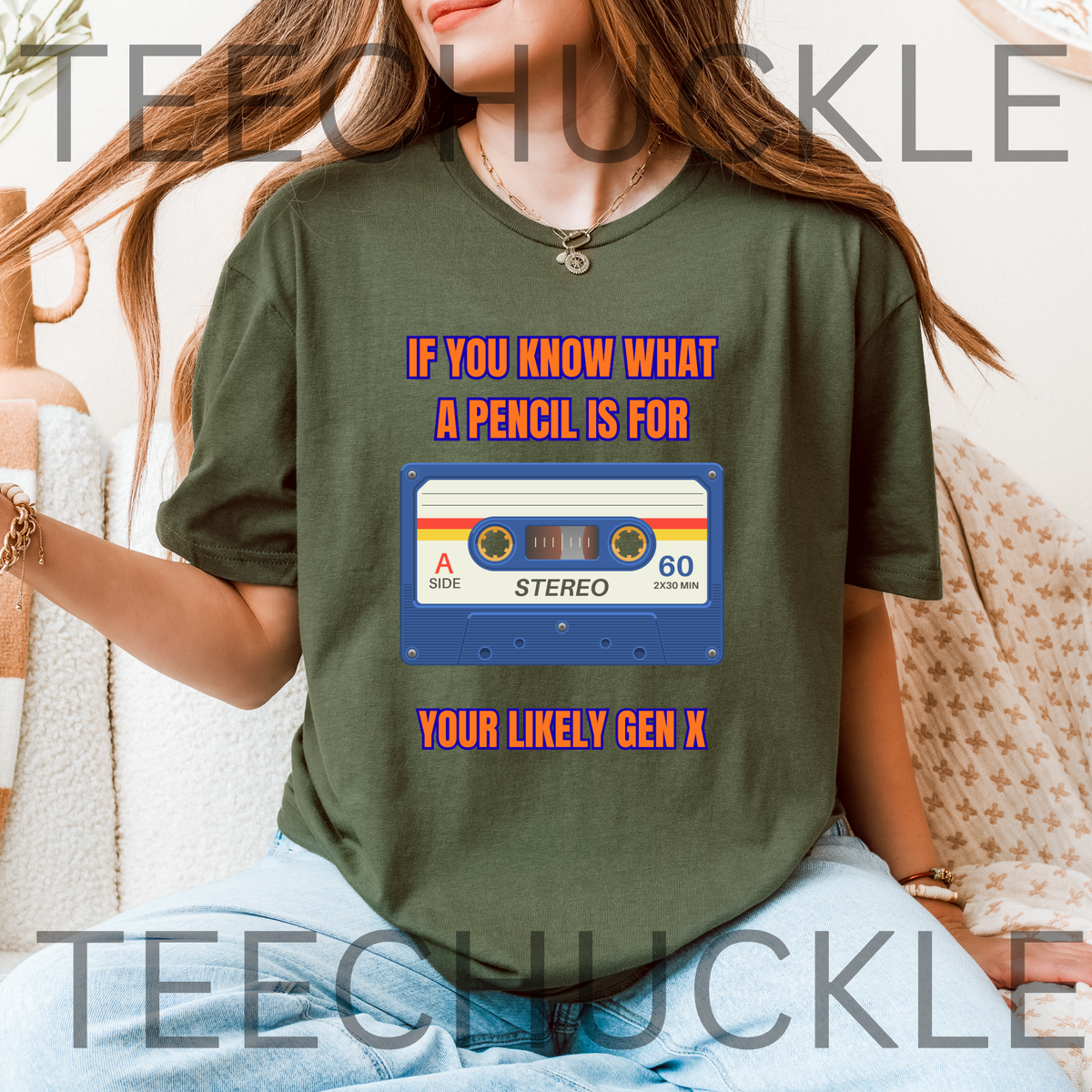 A woman wearing a green graphic t-shirt with a retro cassette tape design and the text 'IF YOU KNOW WHAT A PENCIL IS FOR YOUR LIKELY GEN X'.