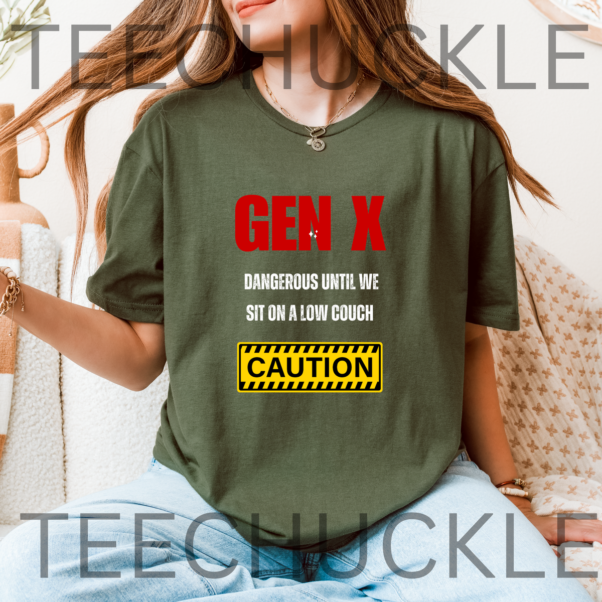 A woman wearing a green graphic t-shirt with a red and white 'GEN X DANGEROUS UNTIL WE SIT ON A LOW COUCH' slogan and a yellow caution sign graphic. 