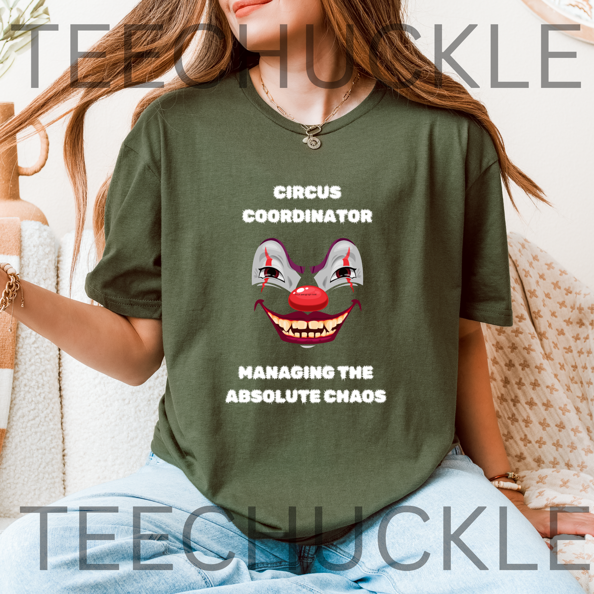 A woman wearing an green graphic t-shirt with a creepy clown face and the text 'CIRCUS COORDINATOR' and 'MANAGING THE ABSOLUTE CHAOS'.