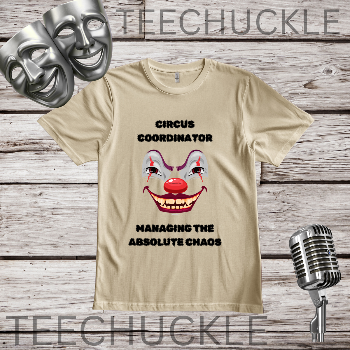 A sand graphic t-shirt featuring a clown face and the text 'CIRCUS COORDINATOR' and 'MANAGING THE ABSOLUTE CHAOS' on a rustic wood plank background, styled with theatrical masks, a vintage microphone