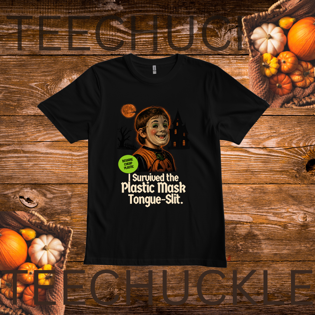 A black short-sleeve graphic T-shirt laid flat on a rustic wooden background with pumpkins around it. The shirt features a cartoon illustration of a smiling boy in a mask with the text 'I Survived the Plastic Mask Tongue-Slit.
