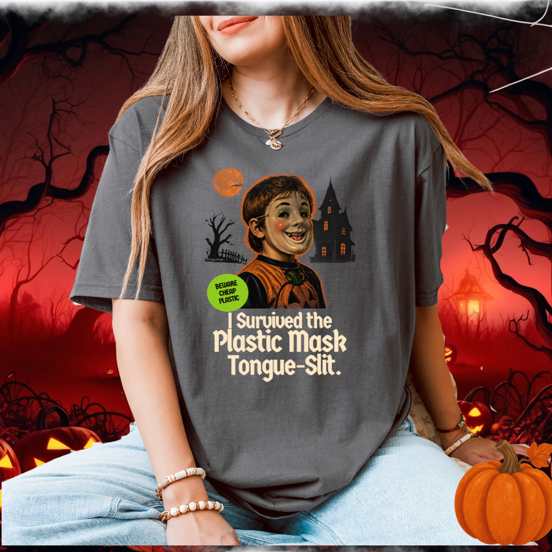 A woman wearing a grey t-shirt with a child in a plastic halloween mask and the text "I URVIVED THE PLASTIC MASK SLIT"