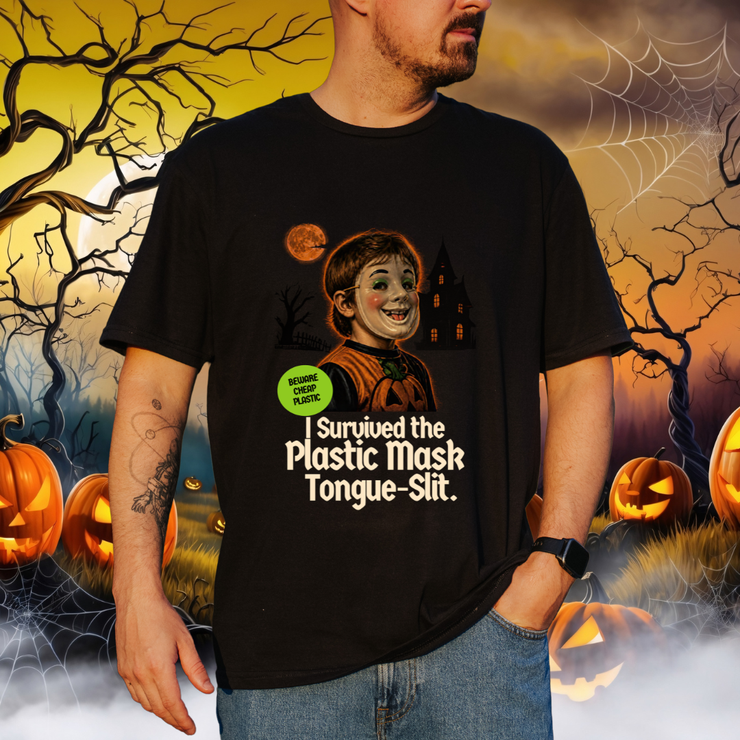 A man wearing a black graphic t-shirt with a Halloween-themed print of a child in a halloween mask and the text 'Survived the Plastic Mask Tongue-Slit.' against a spooky Halloween background with pumpkins, cobwebs, and a full moon.