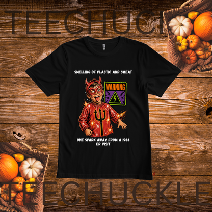 A black graphic t-shirt featuring a devil character holding a pitchfork with text that reads 'SMELLING OF PLASTIC AND SWEAT' and 'ONE SPARK AWAY FROM A 1983 ER VIST'. The shirt is displayed flat on a rustic wooden background decorated with pumpkins and autumn foliage.