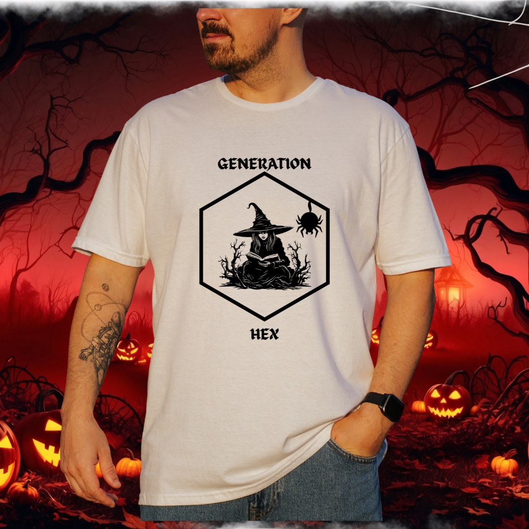 A man wearing a white graphic t-shirt with a black witch illustration and the text 'GENERATION HEX'. The background is a spooky Halloween scene with pumpkins and bare trees.