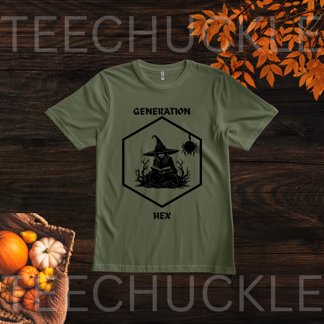 A green graphic t-shirt displayed flat on a dark wood background with autumn-themed props like pumpkins and orange leaves. The t-shirt features a black graphic of a witch sitting in a hexagon with the text 'GENERATION HEX'.