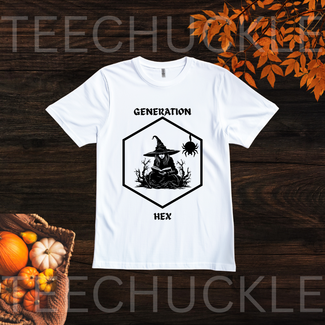 A white short-sleeve graphic T-shirt laid flat on a dark wood background with autumn leaves and pumpkins. The shirt has a black hexagonal witch illustration with the words 'GENERATION' above and 'HEX' below.