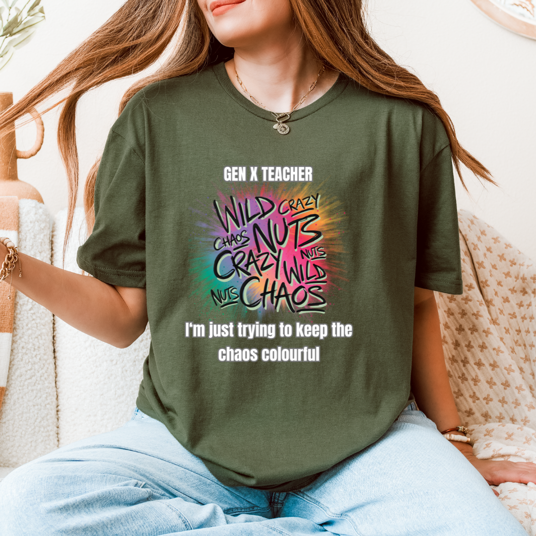 A woman wearing a green graphic t-shirt with a colorful 'Gen X Teacher' design, sitting on a textured beige sofa.