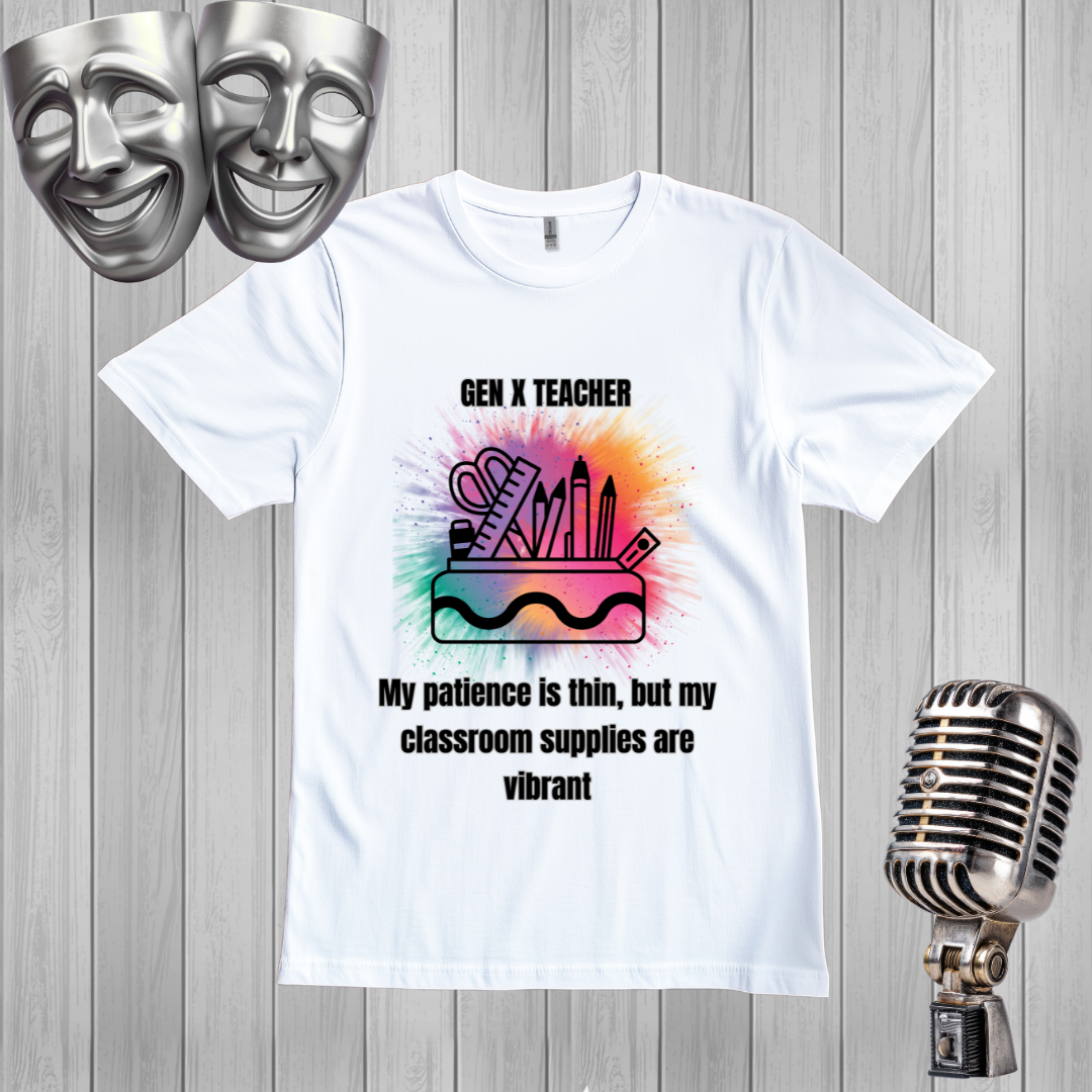 A white graphic t-shirt displayed on a gray wood plank background, flanked by silver-themed props including two comedy masks at the top left and a vintage microphone at the bottom right. The t-shirt features a colorful watercolor-style graphic of classroom supplies with the text 'GEN X TEACHER My patience is thin, but my classroom supplies are vibrant'.