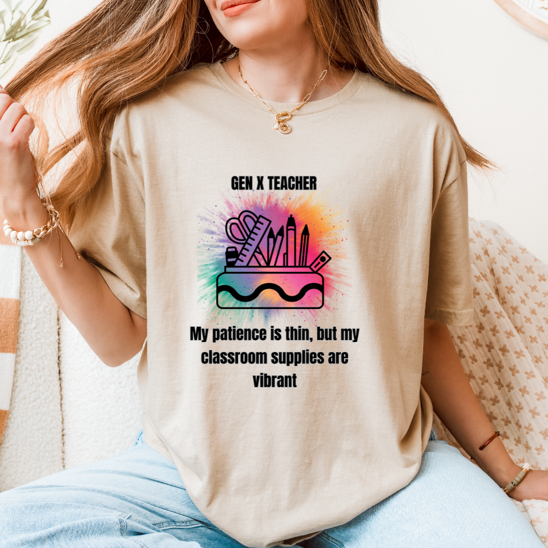 A woman wearing a sand graphic t-shirt with a colorful school supplies design and the text 'GEN X TEACHER My patience is thin, but my classroom supplies are vibrant'.