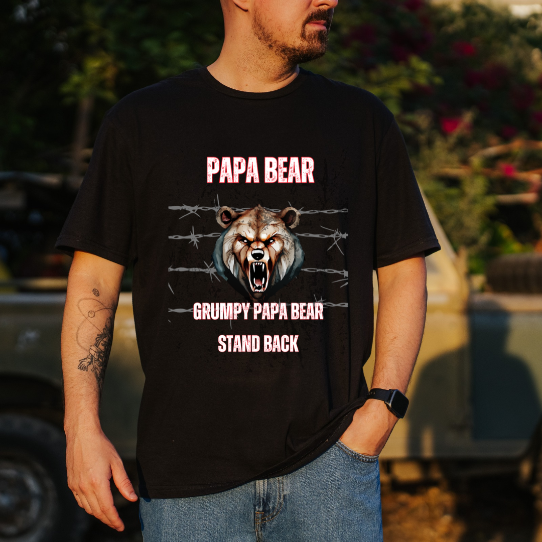 A man wearing a black graphic t-shirt with a grumpy bear design and the text 'PAPA BEAR' and 'GRUMPY PAPA BEAR STAND BACK'.