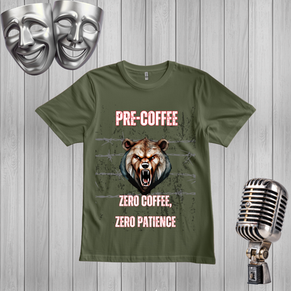 A green graphic t-shirt displayed on a light gray wood plank background, styled with a silver vintage microphone on the right, two silver comedy masks at the top left, and a distressed brown bear graphic with the text 'PRE-COFFEE ZERO COFFEE, ZERO PATIENCE'.