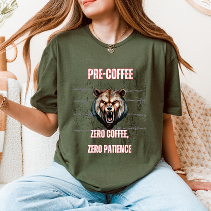 A woman wearing a green graphic t-shirt with a roaring bear design and the text 'PRE-COFFEE ZERO COFFEE, ZERO PATIENCE'.