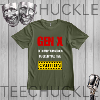 A green graphic t-shirt displayed on a gray wood-plank background. The shirt features a red and white text design reading 'GEN X EXTREMELY DANGEROUS BEFORE MY BED TIME' and a yellow 'CAUTION' warning label graphic.