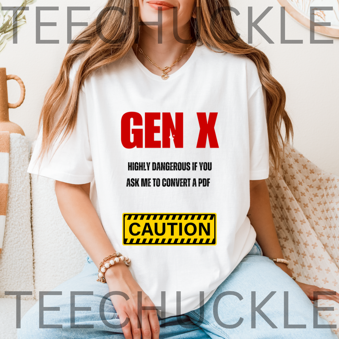 A woman wearing a white graphic T-shirt with the text 'GEN X' in red, smaller black text underneath, and a yellow caution-style box reading 'CAUTION'. The photo is styled in a home setting.