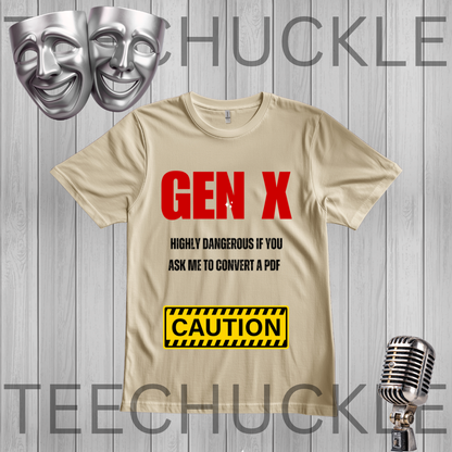 A sand graphic t-shirt featuring the text 'GEN X' in bold red, followed by 'HIGHLY DANGEROUS IF YOU ASK ME TO CONVERT A PDF' in black, and a yellow 'CAUTION' sign graphic. The t-shirt is displayed on a gray wood-plank background  silver theater masks, and a vintage microphone.