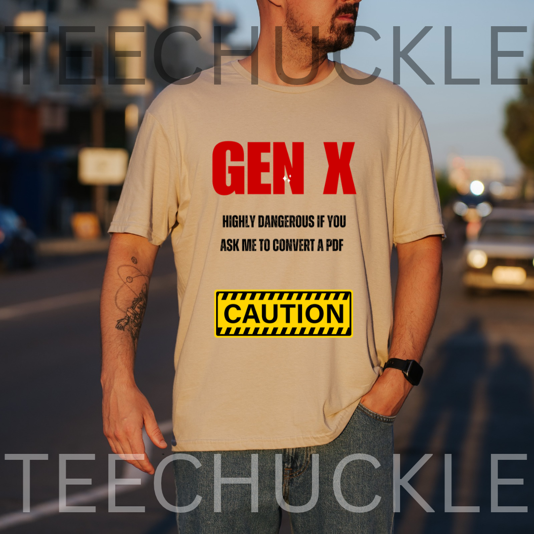 A man wearing a sand graphic t-shirt with red and black text reading 'GEN X HIGHLY DANGEROUS IF YOU ASK ME TO CONVERT A PDF' and a yellow 'CAUTION' sign graphic, set against a blurred street background.
