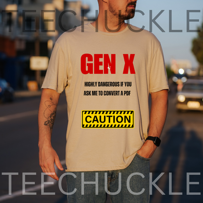 A man wearing a sand graphic t-shirt with red and black text reading 'GEN X HIGHLY DANGEROUS IF YOU ASK ME TO CONVERT A PDF' and a yellow 'CAUTION' sign graphic, set against a blurred street background.