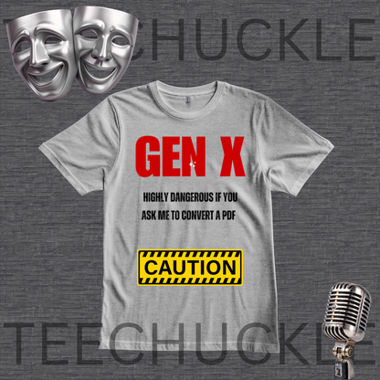 A gray graphic t-shirt featuring the text 'GEN X' in bold red, followed by 'HIGHLY DANGEROUS IF YOU ASK ME TO CONVERT ME TO A PDF' in black, and a yellow 'CAUTION' warning label. The t-shirt is displayed on a dark gray textured background with theatrical masks, a vintage microphone,