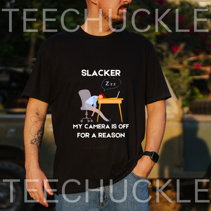 A black graphic t-shirt  featuring a cartoon illustration of a person sleeping at a desk with the text 'SLACKER, MY CAMERA IS OFF FOR A REASON'. 