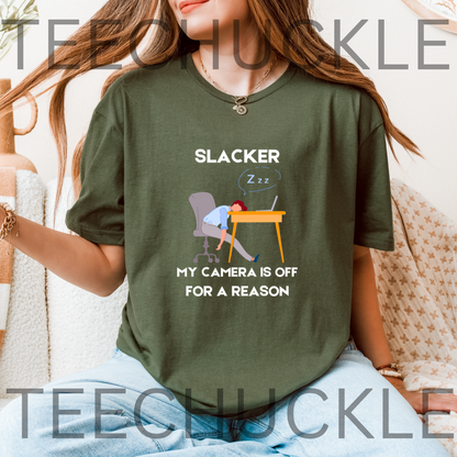 A green graphic t-shirt featuring a cartoon illustration of a person sleeping at a desk with the text 'SLACKER, MY CAMERA IS OFF FOR A REASON'. 