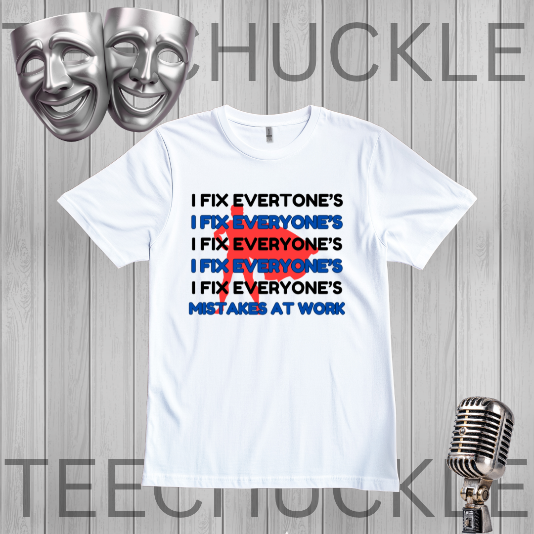 A white graphic t-shirt displayed on a gray wood-plank background, featuring a text design that reads 'I FIX EVERYONE'S MISTAKES AT WORK' with a red scribble over repeated 'I FIX EVERYONE'S' lines. Silver theater masks and a vintage microphone are placed around the shirt