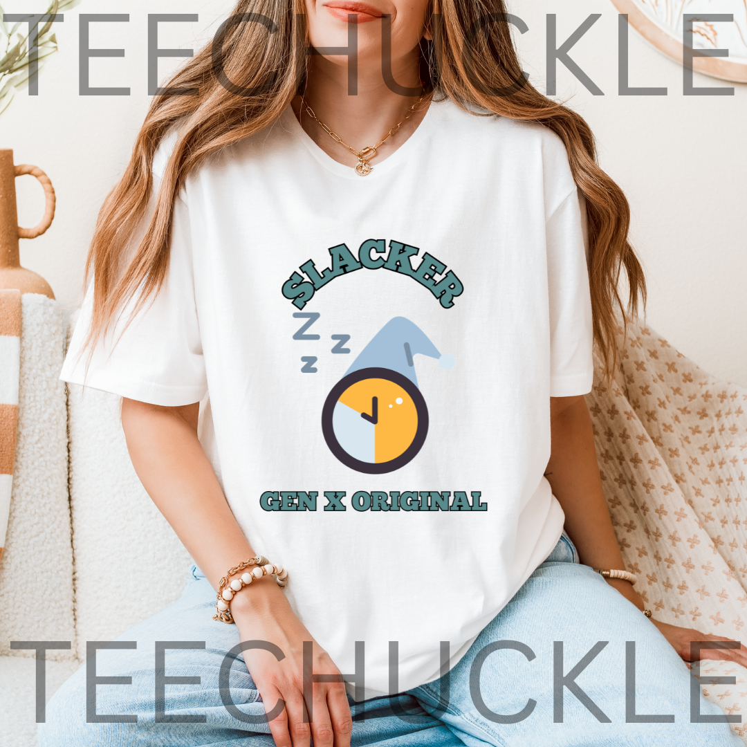A woman wearing a white graphic t-shirt with a 'Slacker Gen X Original' sleep-themed design, sitting in a cozy indoor setting. The t-shirt features a cartoon clock and 'Z' sleep marks.