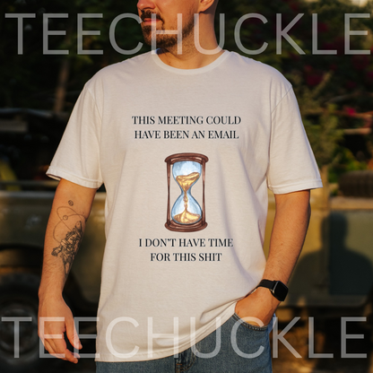 A man wearing a white graphic t-shirt with a humorous text and hourglass print, set against an outdoor blurred background 