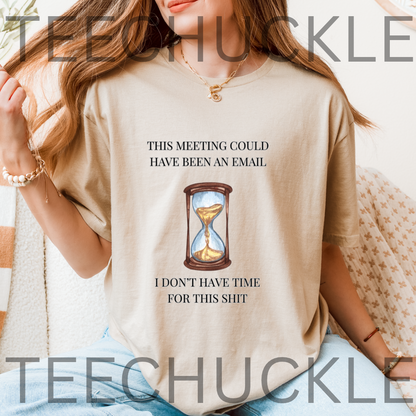 A woman wearing a sand graphic t-shirt with the text 'THIS MEETING COULD HAVE BEEN AN EMAIL' above an hourglass illustration and 'I DON'T HAVE TIME FOR THIS SHIT' below. 