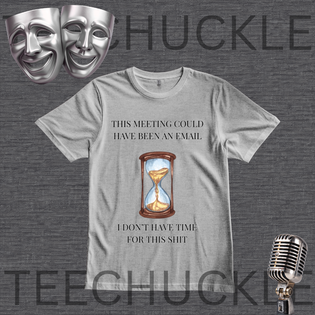 A gray graphic t-shirt featuring a humorous meeting-related quote and an hourglass illustration. The t-shirt is displayed on a dark gray textured background with theatrical comedy and tragedy masks in the top-left corner and a vintage microphone in the bottom-right corner.